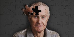 Jigsaw puzzle, of senior man, falling apart